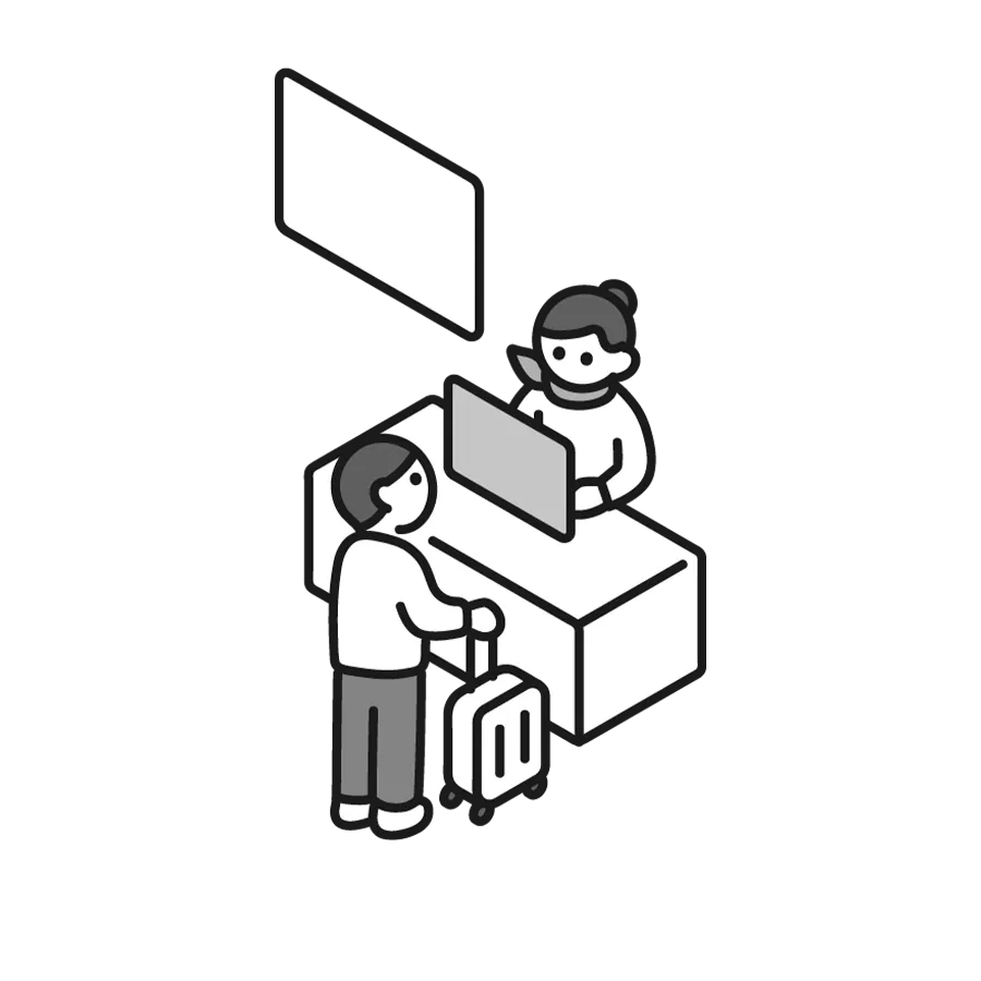 空港のチェックインカウンターで手続きをする男性